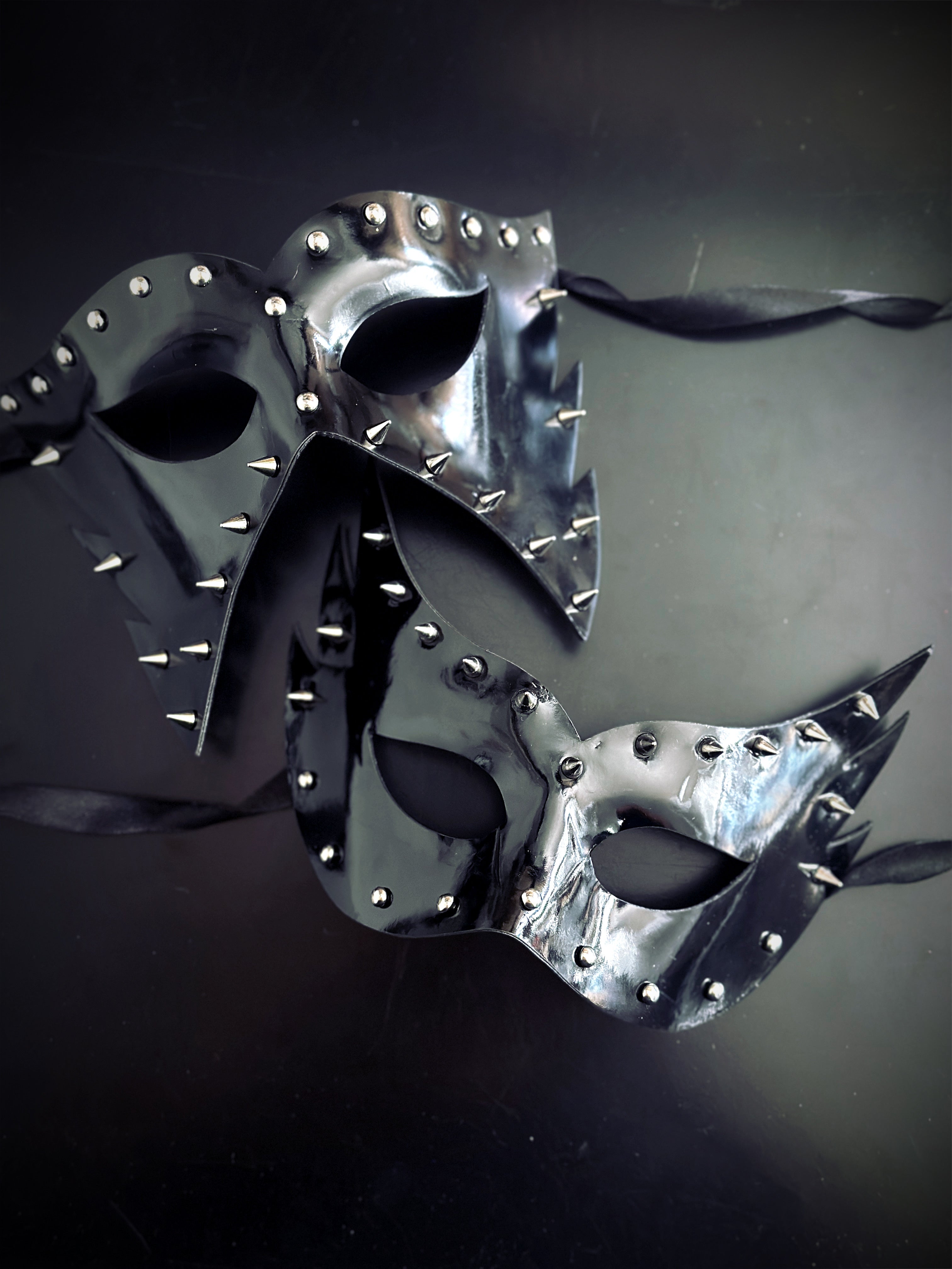 Couples black pleather masquerade masks with studs and spikes.