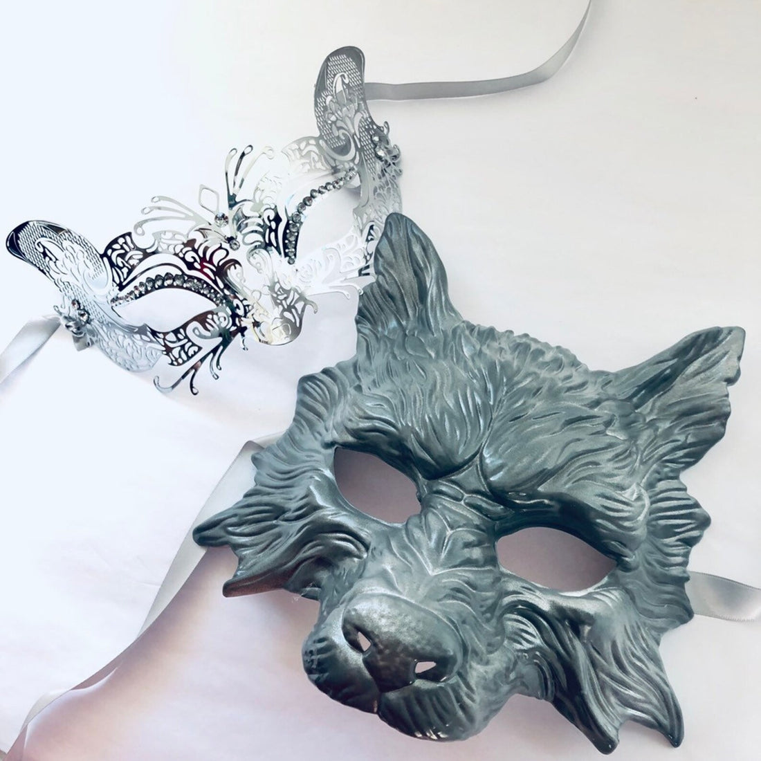 Silver fox and black wolf masquerade mask set for sale.