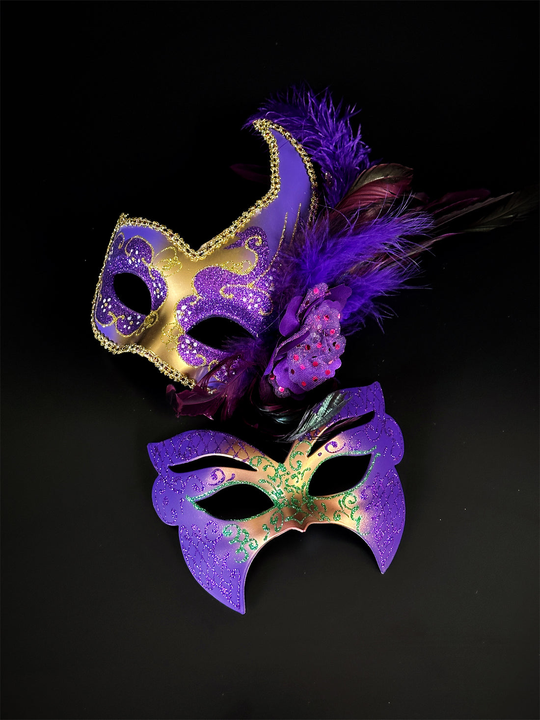 Couples mardi gras masks in purple, gold, and green.
