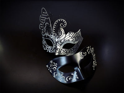Womens butterfly mask in silver and black and men's black mask with silver filigree.