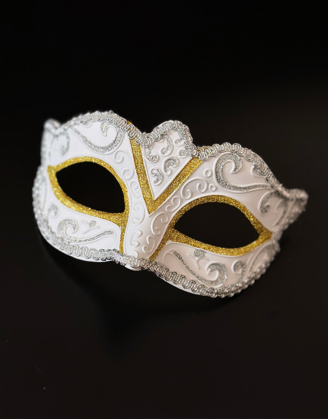 White Venetian masquerade mask with gold and silver glitter detailing for elegant formal events.