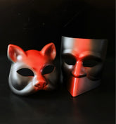 Red and black dual-style masquerade mask set with fox and modern face designs for theatrical events.