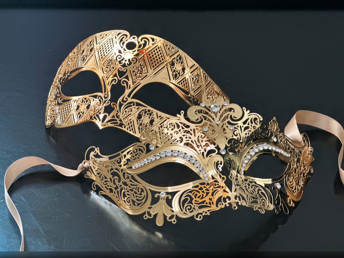 Gold couples masquerade masks with rhinestones and filigree lace cut-outs on black background