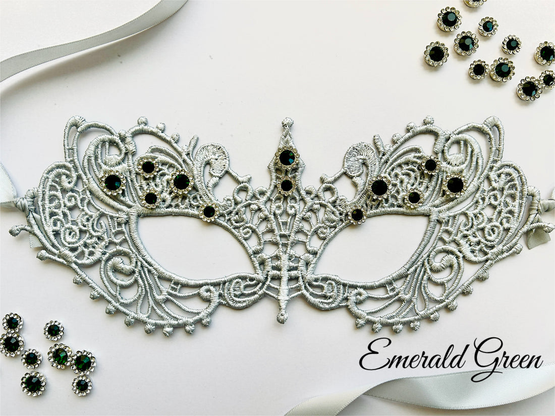 Silver lace masquerade mask with emerald green rhinestones for formal gala and Venetian ballroom occasions.