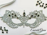 Silver lace masquerade mask with emerald green rhinestones for formal gala and Venetian ballroom occasions.