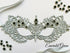 Silver lace masquerade mask with emerald green rhinestones for formal gala and Venetian ballroom occasions.