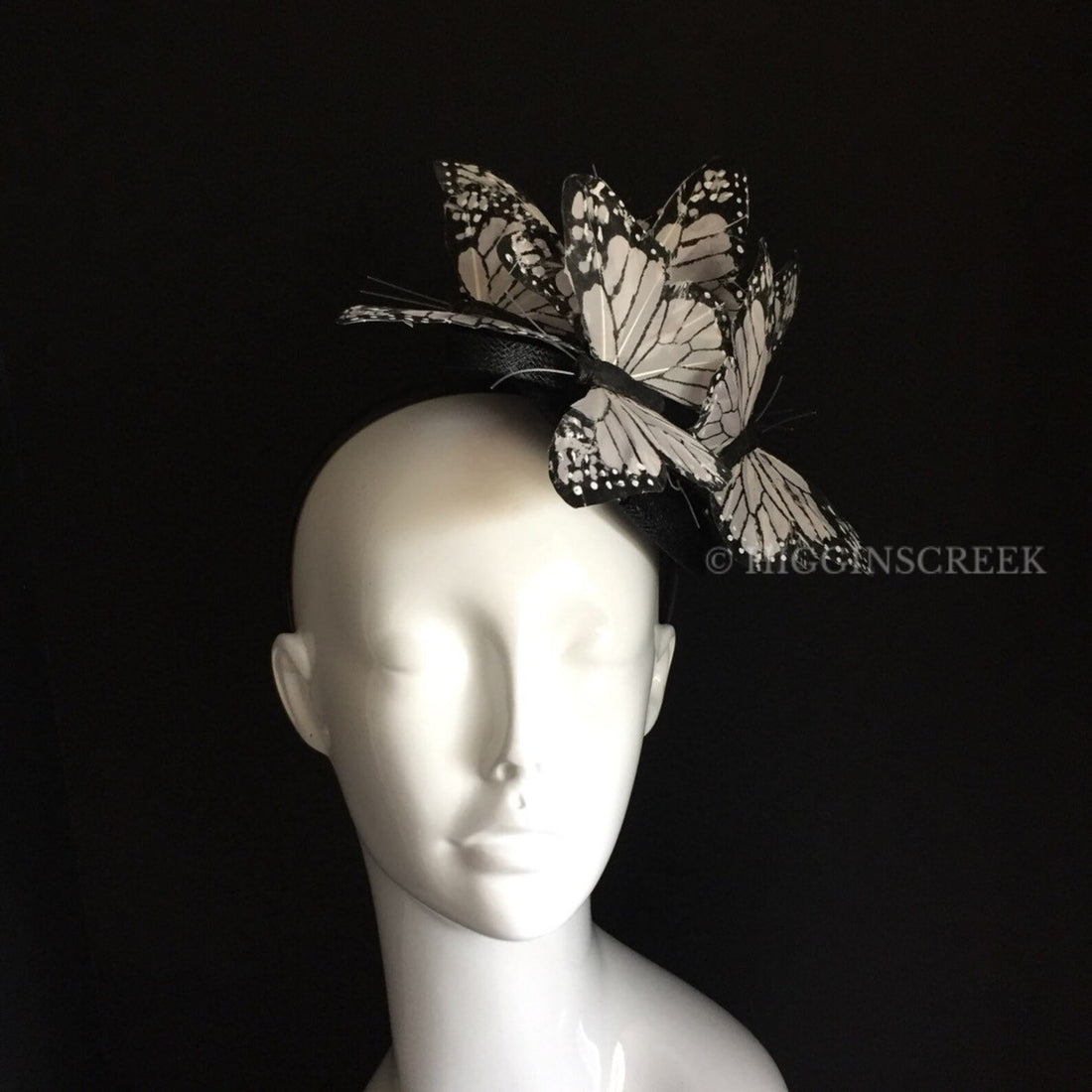 Kentucky derby style tea party fascinator hat with six white/black butterflies on a black base for sale.