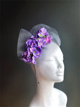 Purple flowers on a silver fascinator tulle base with a headband.