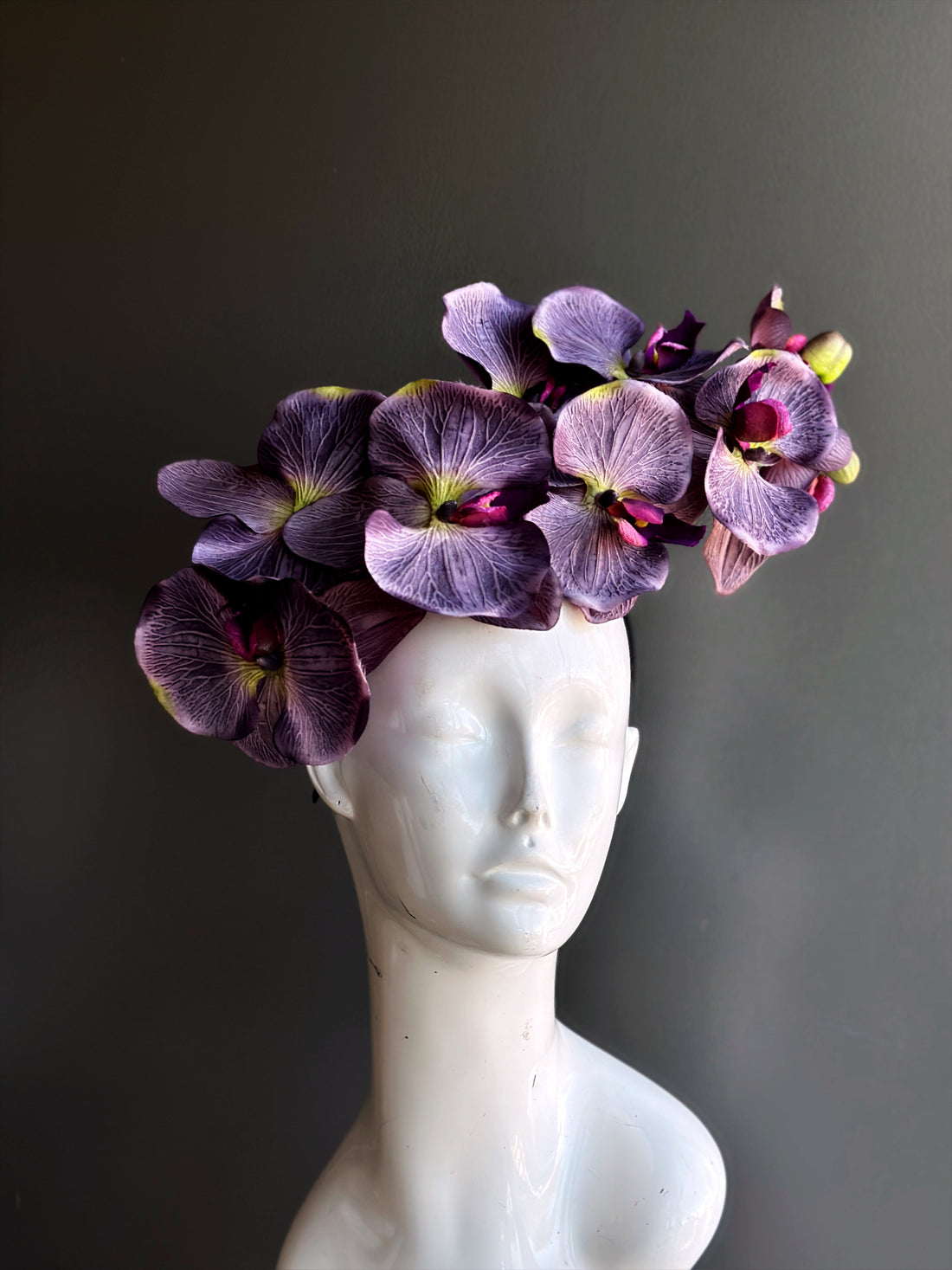 Purple orchid flower fascinator hat on a headband.