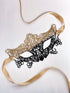 Delicate gold lace masquerade mask with black accents, ideal for formal parties