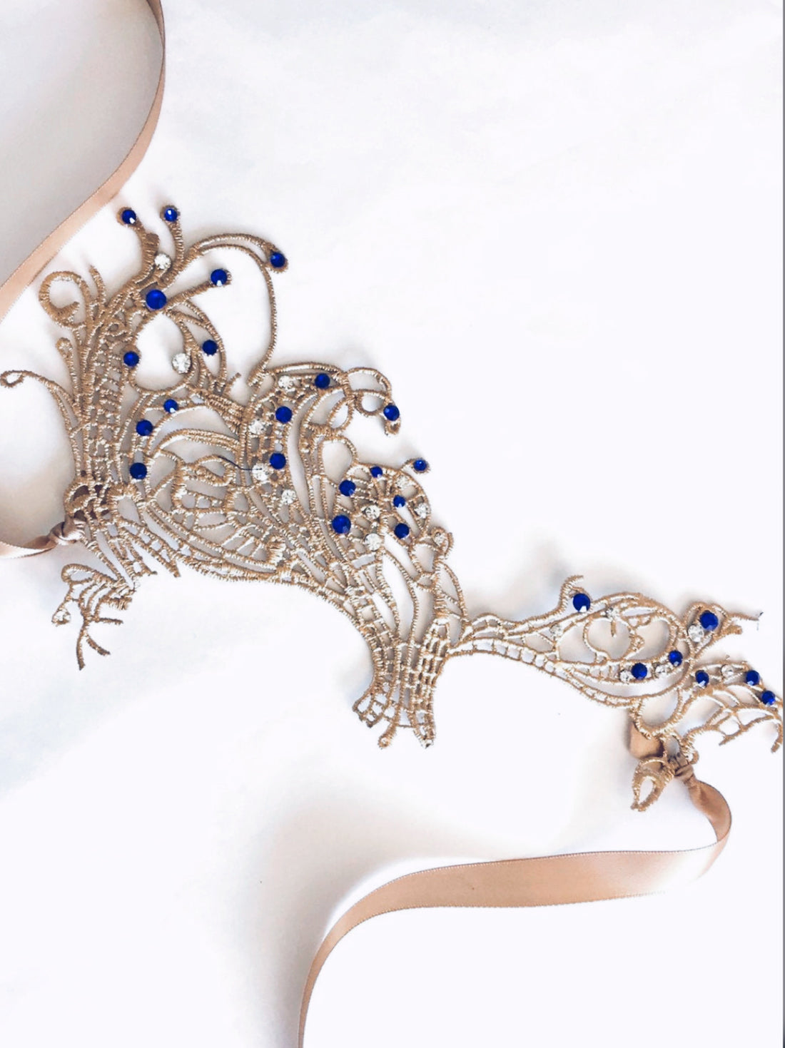 Intricate gold masquerade mask for women with sapphire gem details