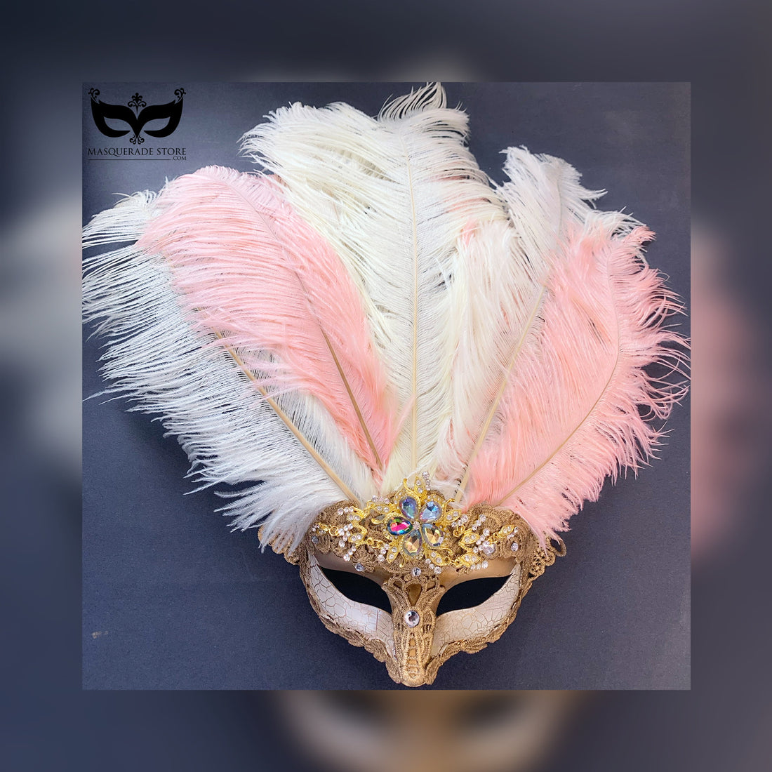 Feathered masquerade mask in gold with pastel blush and white plumes and crystal accents