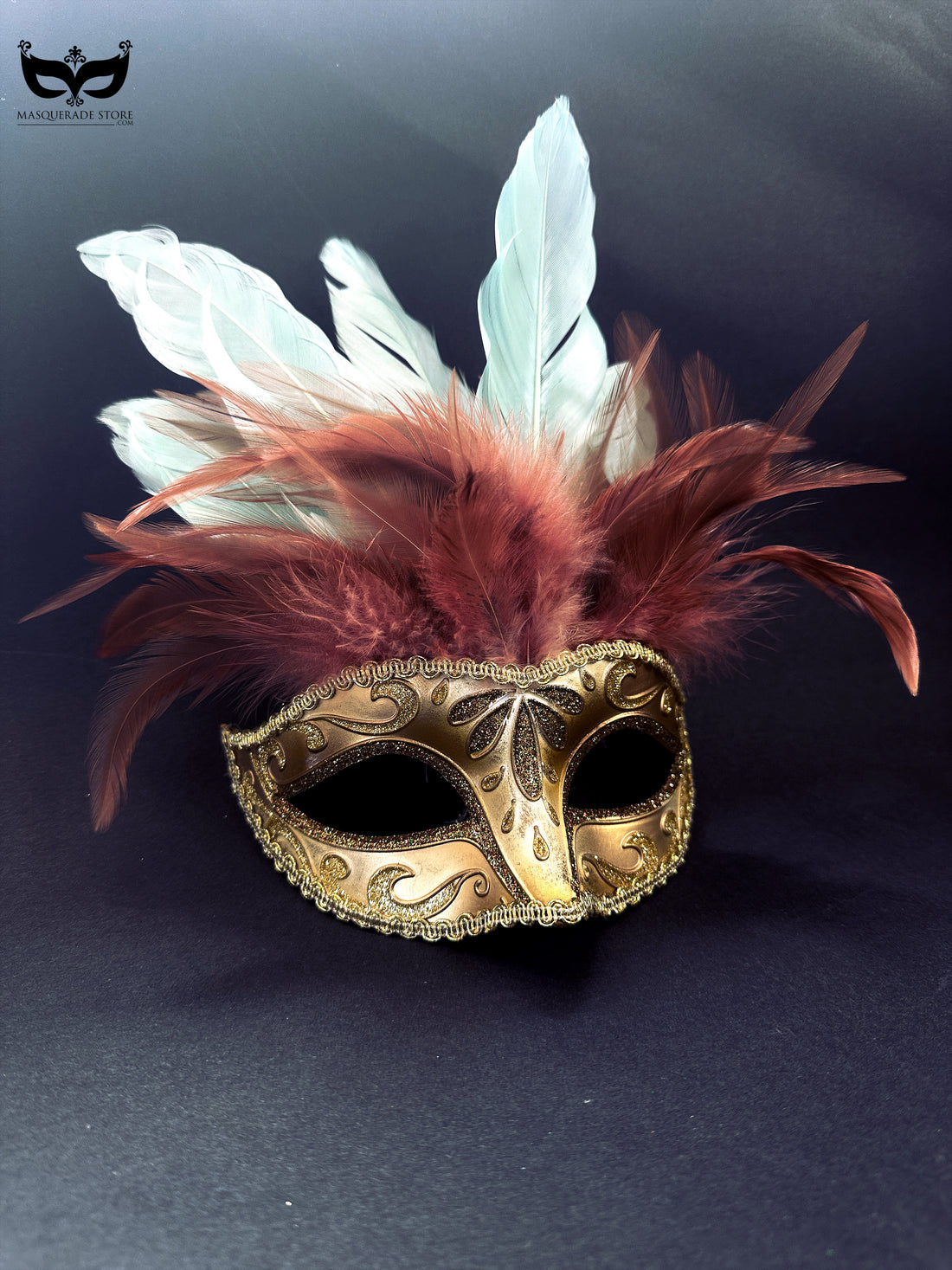 Gold masquerade mask with glitter details and red and white feather plumes for Mardi Gras and balls