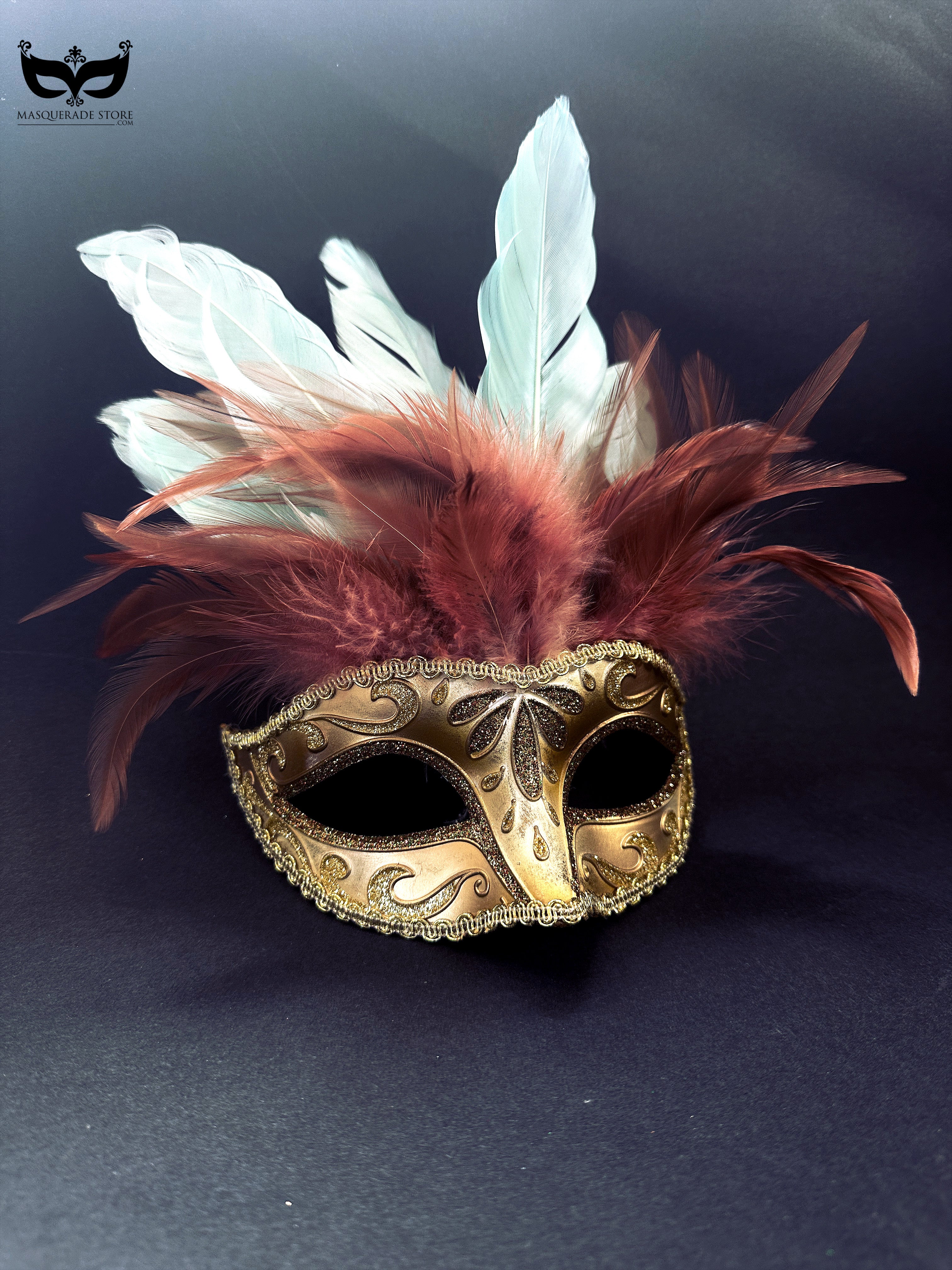 Gold masquerade mask with glitter details and red and white feather plumes for Mardi Gras and balls