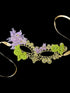 Gold lace masquerade mask with lilac and green floral embellishments, perfect for Mardi Gras, prom, and costume parties.