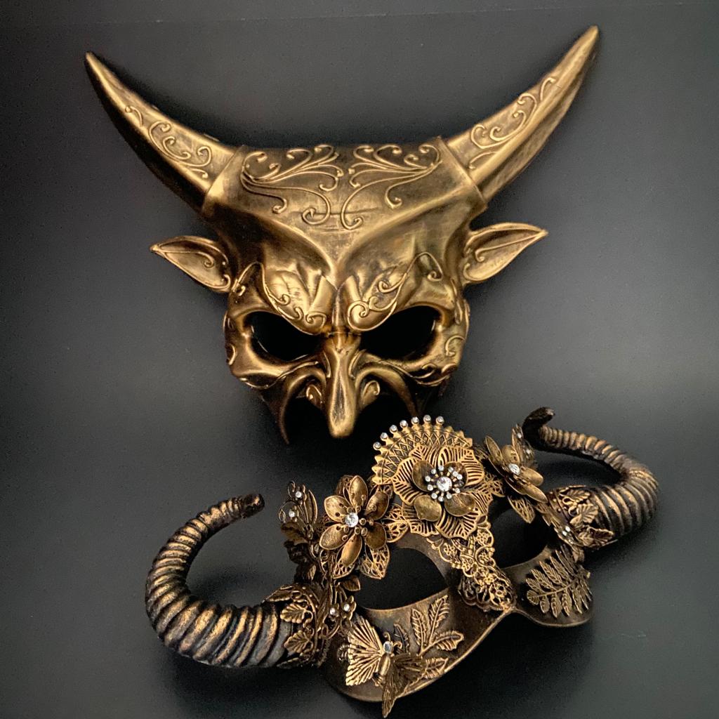 Couples gold masquerade masks featuring devil horn mask and ornate floral horn mask with fantasy details