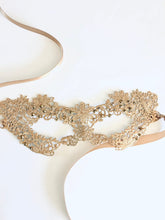 Elegant gold masquerade mask with delicate lace and shimmer details for formal events or romantic masquerade nights.