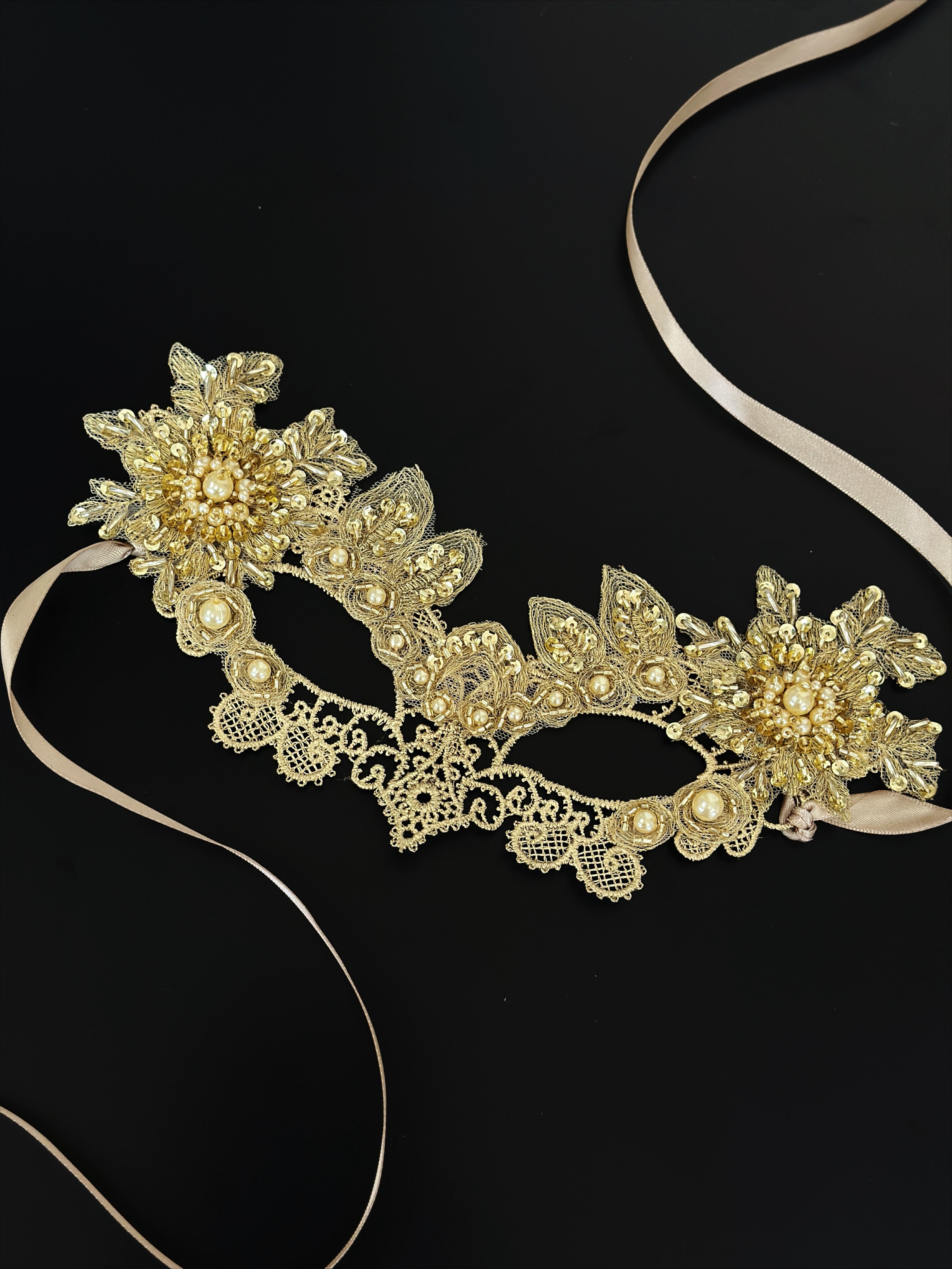 Elegant gold lace masquerade mask with pearl accents and floral design, ideal for proms, weddings, and masquerade balls.