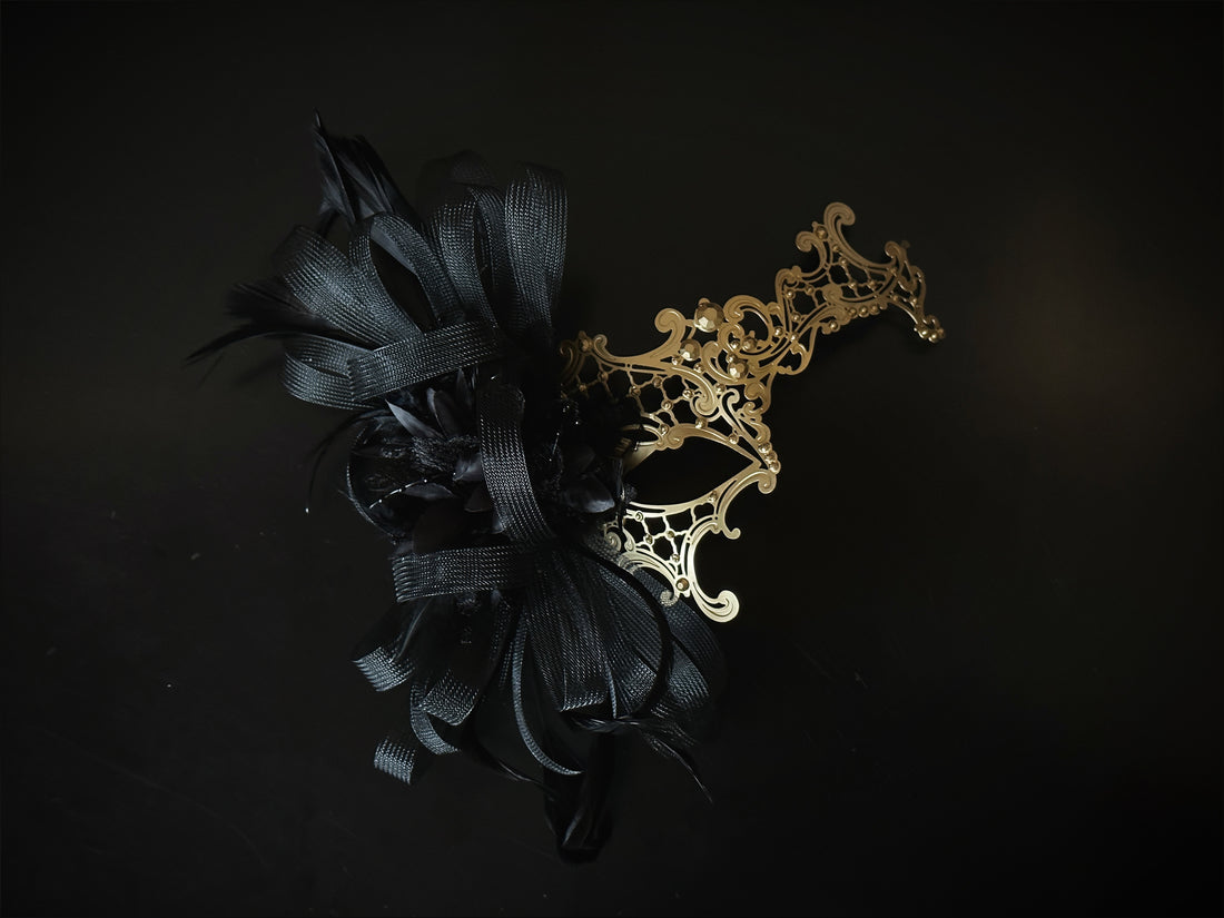 Gold baroque masquerade mask with filigree scrollwork and black feather and tulle accent for prom or Halloween