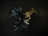 Gold baroque masquerade mask with filigree scrollwork and black feather and tulle accent for prom or Halloween