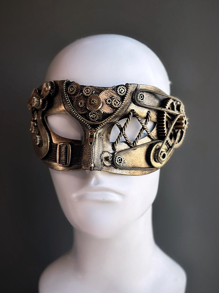 Masquerade mask in gold with vintage steampunk gear accents and industrial textures for fantasy or Halloween wear