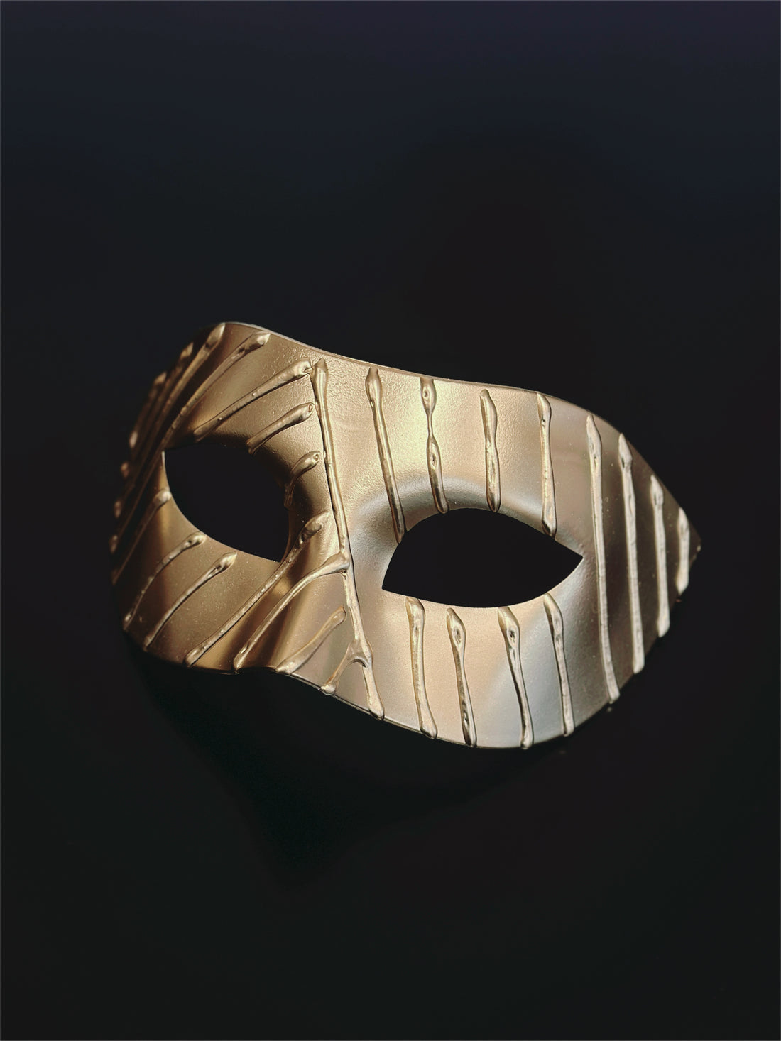Elegant gold Venetian masquerade mask with textured finish for men and women.