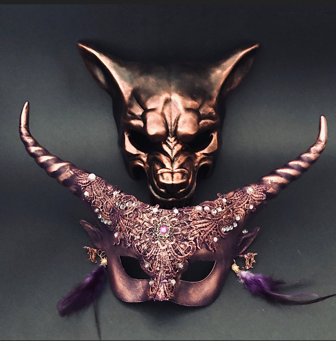 Elegant gold masquerade masks for couples with twisted horns, floral embellishments, and wolf design