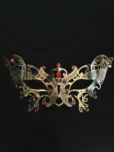 Gold women’s masquerade mask with filigree metal design and red rhinestones, perfect for Venetian masquerade balls, Mardi Gras, and prom.
