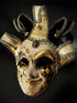 Gold and black Venetian jester mask with ornate baroque detailing and harlequin diamonds.
