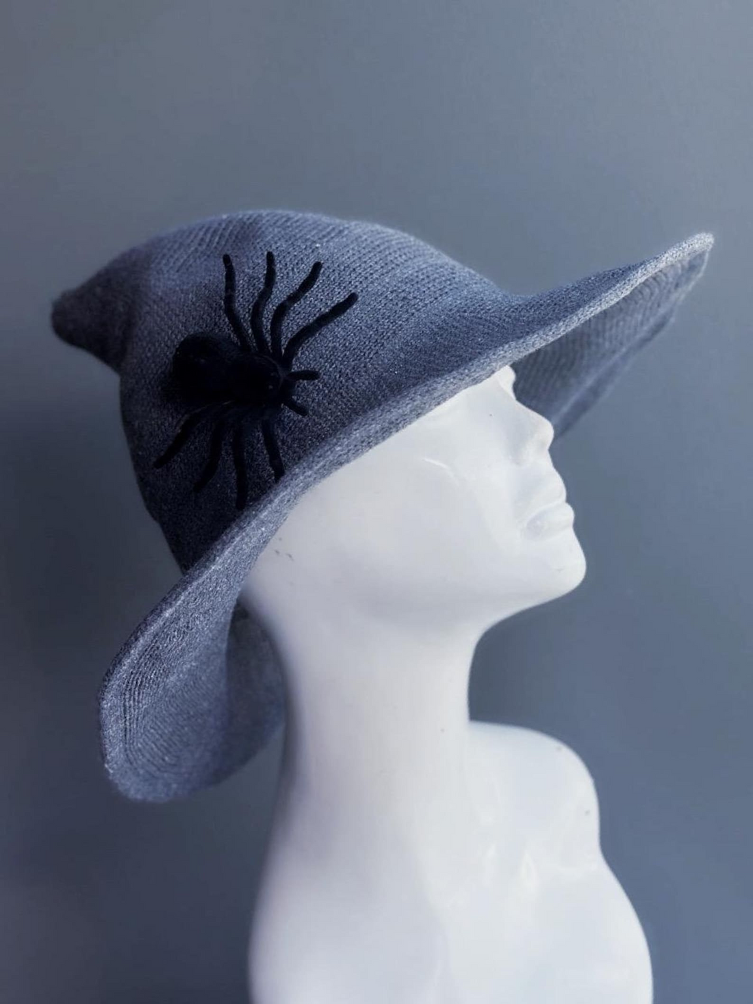 Gray witch hat with black spider accent for Halloween, gothic, or cosplay costumes.