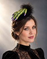 Green Spell Witch Hand Fascinator with realistic green witch hand, purple fingernails, black feathers, and Halloween styling.