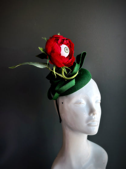 Halloween eyeball flower fascinator hat with red rose and creepy eyeball center, gothic headpiece for haunted parties and costumes.
