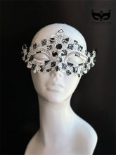 Haunted Filigree black and white metal masquerade mask with ornate open scrollwork, crystal rhinestone trim, pointed details, and Halloween styling.