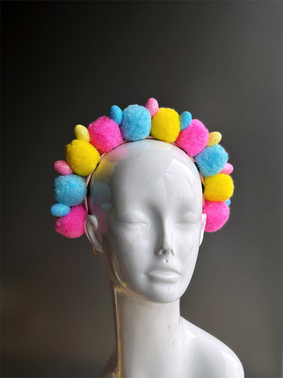 Headband with fuzzy pompom balls in pink/blue/yellow with easter eggs