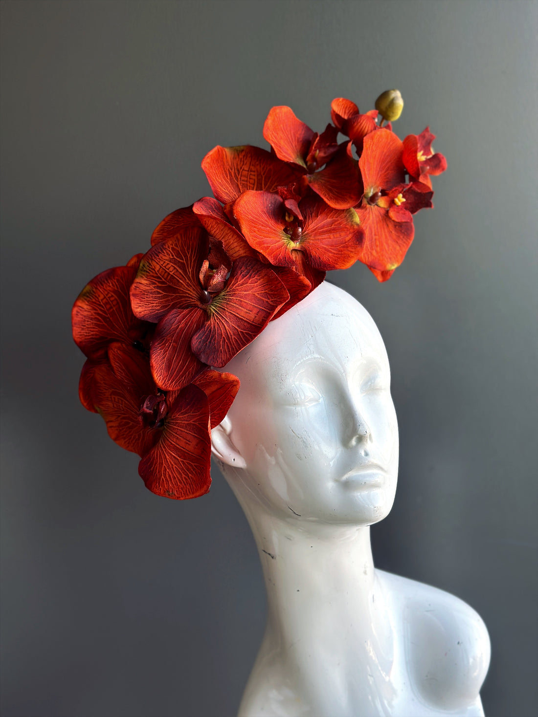 orange orchid flower fascinator hat.