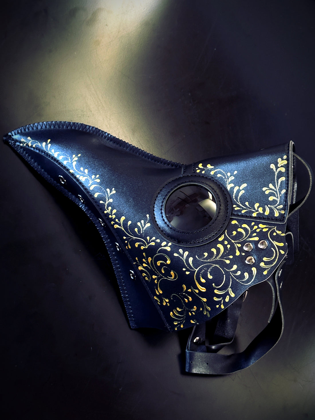 Black plague mask with yellow gold filigree for sale.