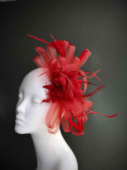 red fascinator hat with feather and tulle floral detailing