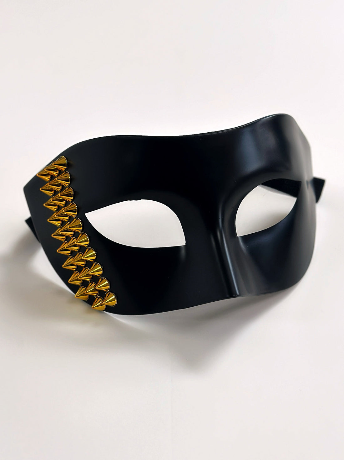 Black masquerade mask for men with gold stud details, perfect for edgy masquerade looks