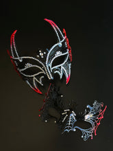 Red and black couples masquerade mask set with a horned rhinestone masquerade mask and a spiderweb-style eye mask for gothic formal events.