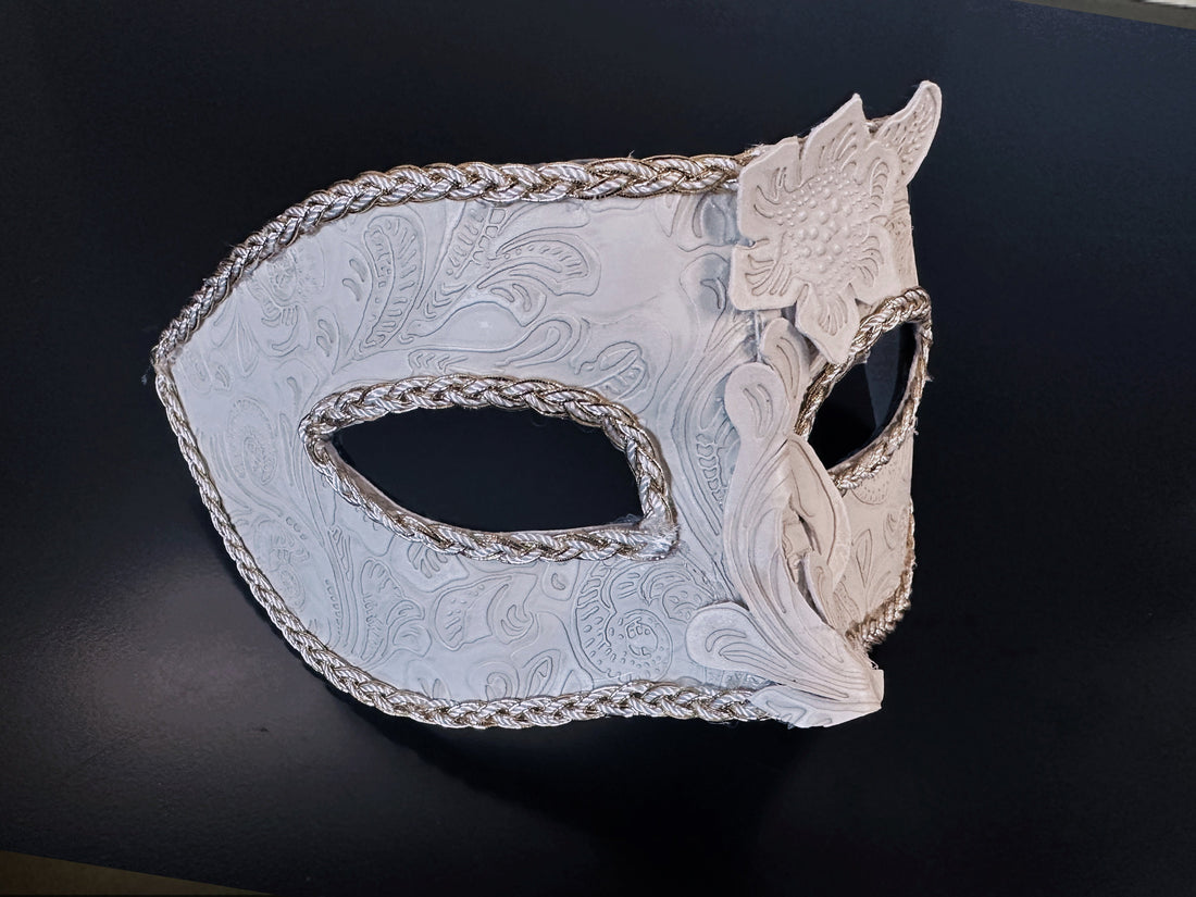 Elegant white Venetian masquerade mask with embossed floral details and silver braid trim for men.