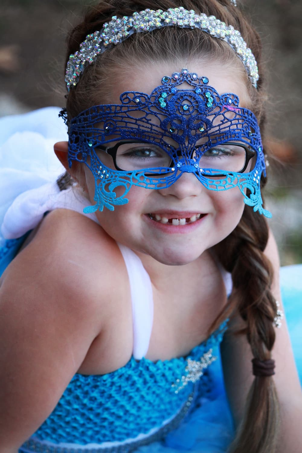 Kids masquerade mask in shades of blue with iridescent rhinestones.
