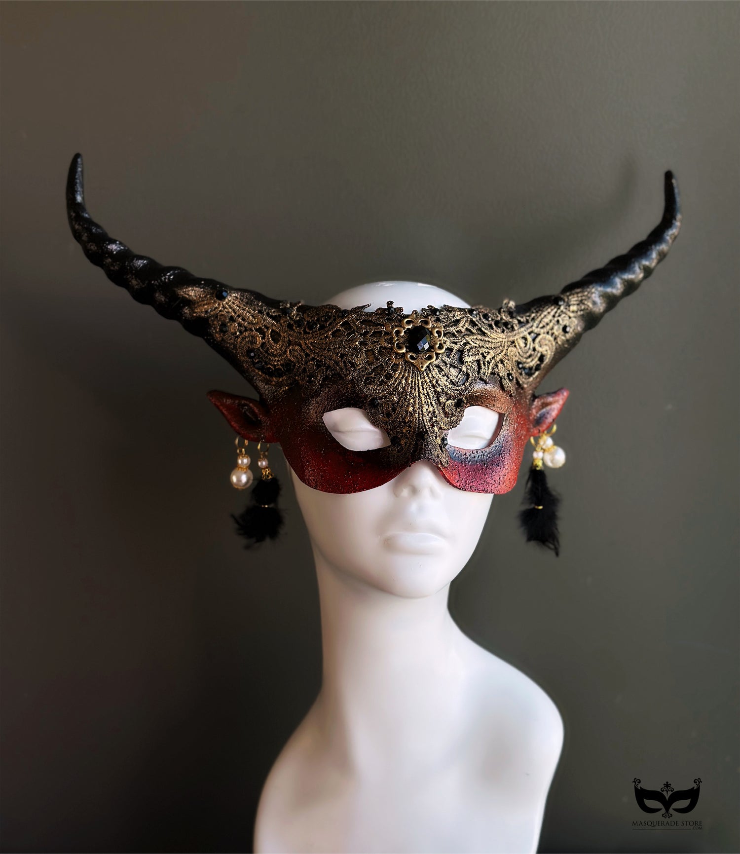 Horned black and gold masquerade mask with lace and tassels for gothic formal events.