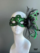 Green lace masquerade mask with iridescent crystal accents styled for formal masquerade balls and evening galas.