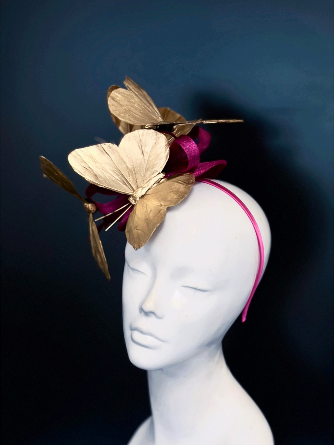 Magenta fascinator hat with metallic gold butterfly headpiece for weddings and Derby.