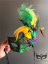 Vibrant feathered carnival mask in traditional Mardi Gras colors with glitter finish
