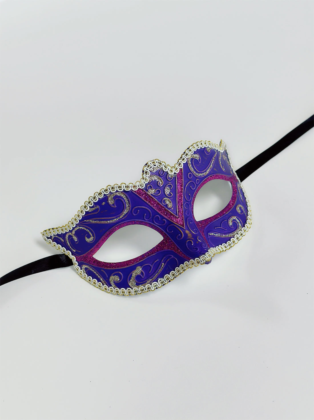 Festive Mardi Gras masquerade mask in purple, pink, and gold glitter, perfect for carnival parades, balls, and masquerade parties.