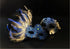 Blue feather masquerade mask set with lace accent for formal costume events.