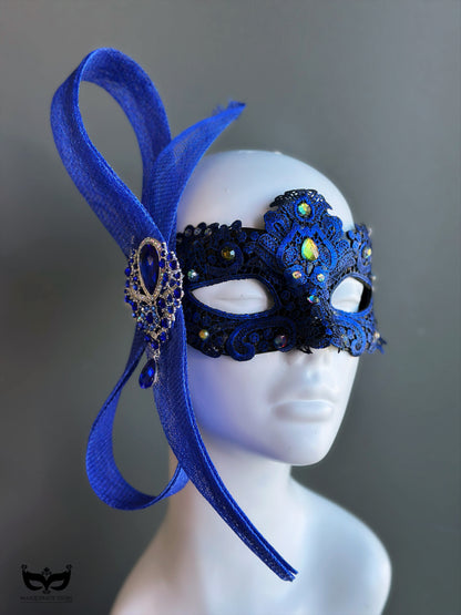 Royal blue lace masquerade mask with iridescent crystal accents styled for formal masquerade balls and evening galas.