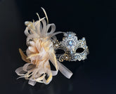 Gold lace masquerade mask with blue crystal details and champagne feather accent for weddings and formal masquerade events.