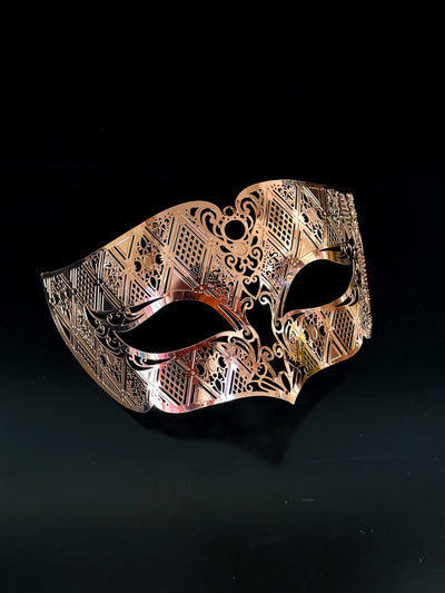 Men's laser cut metal masquerade mask in rose gold.